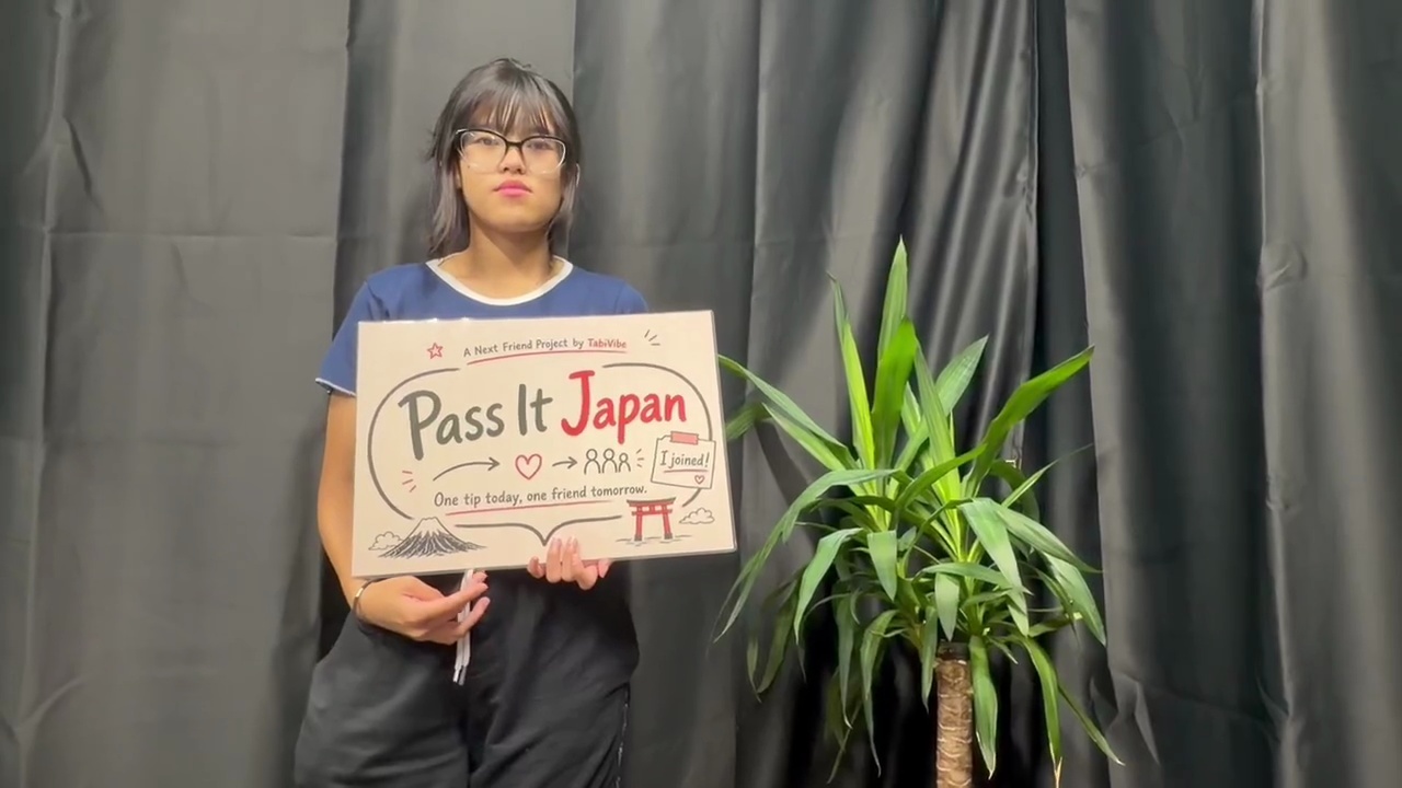 Eli holding the Pass It Japan sign