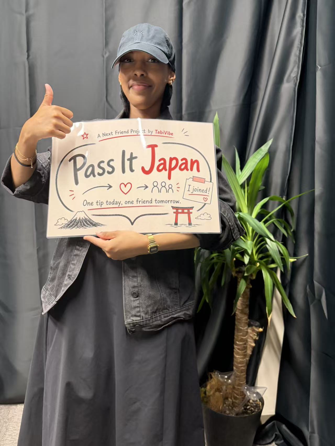 Mia holding the Pass It Japan sign